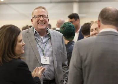 group of people laughing and talking at an event