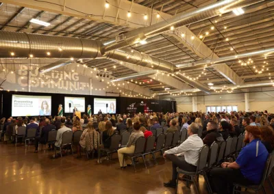 large group of people in event space at a conference