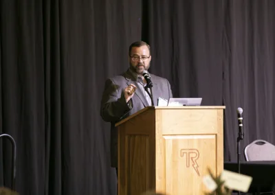 person speaking on stage at an event