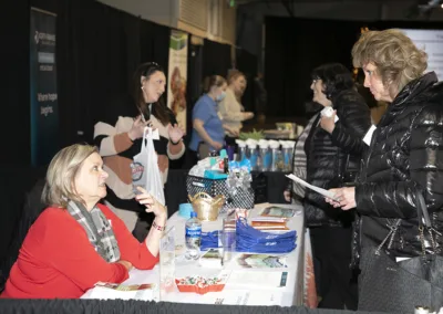 person working at tradeshow booth at an event