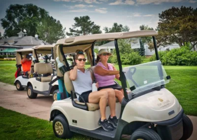 group of people on golf carts on a golf course