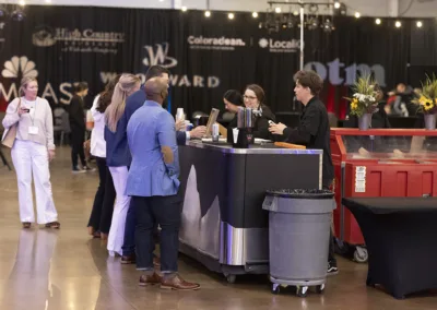 people talking at a tradeshow booth at an event
