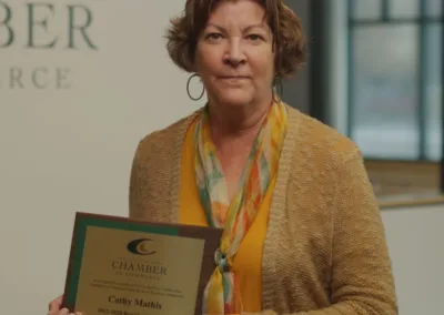 woman holding plaque award at an event