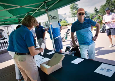 person working at registration booth at golf course tournament