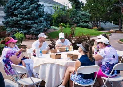 group of people eating outside of golf course club house