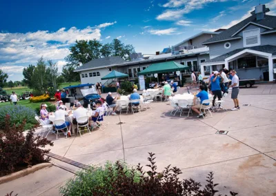 group of people eating outside of golf course club house