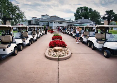 lots of golf carts in front of club house