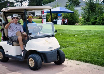 people on a golf cart on a golf course