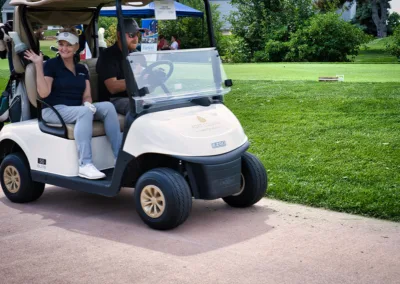 people on a golf cart on a golf course