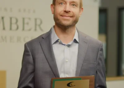 Person holding an award at an event