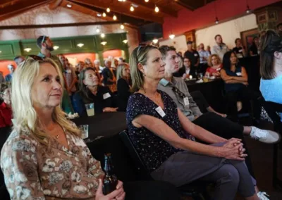 people in audience listening to a speaker at an event