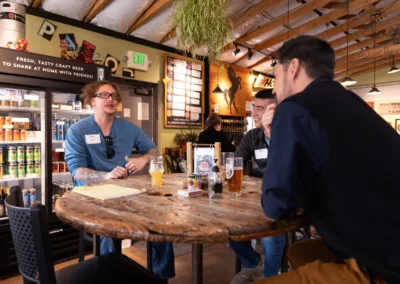 Three men sitting at a high-top talking