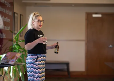 A woman standing next to a screen presenting