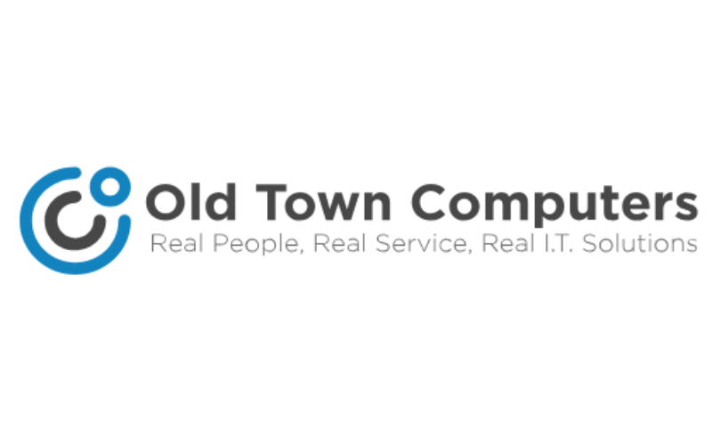 Logo of "Old Town Computers". It features a stylized blue and grey circular design followed by the company name in bold grey text. Below it, the tagline reads: "Real People, Real Service, Real I.T. Solutions".