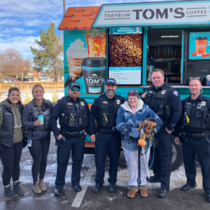 Group photo with pedestrians and police officers Infront of a food/coffee truck