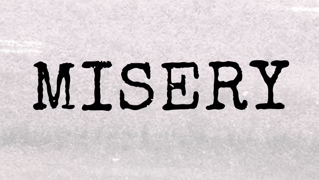 The word "MISERY" is written in bold, black, uppercase, typewriter-style font on a textured, light gray background.