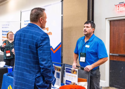 A man standing next to another man.