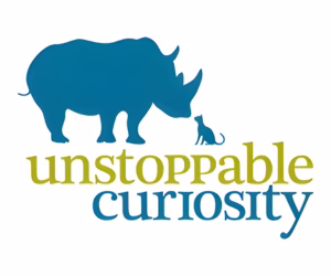 A blue silhouette of a rhinoceros faces a small cat, with the words "unstoppable curiosity" in green and blue text below them.