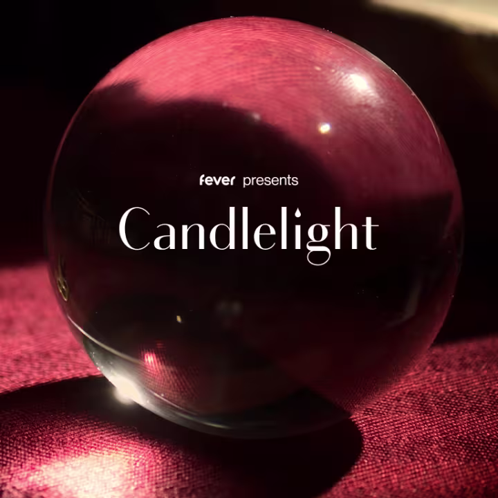 A glass sphere rests on a red textured surface, reflecting light. The words "fever presents Candlelight" appear over the sphere in white text.